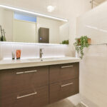 Interior of modern bathroom with bathtub and mirror